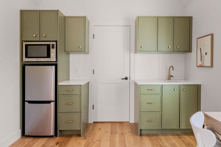 Detached bonus space features refrigerator, sink, and multi-oven.