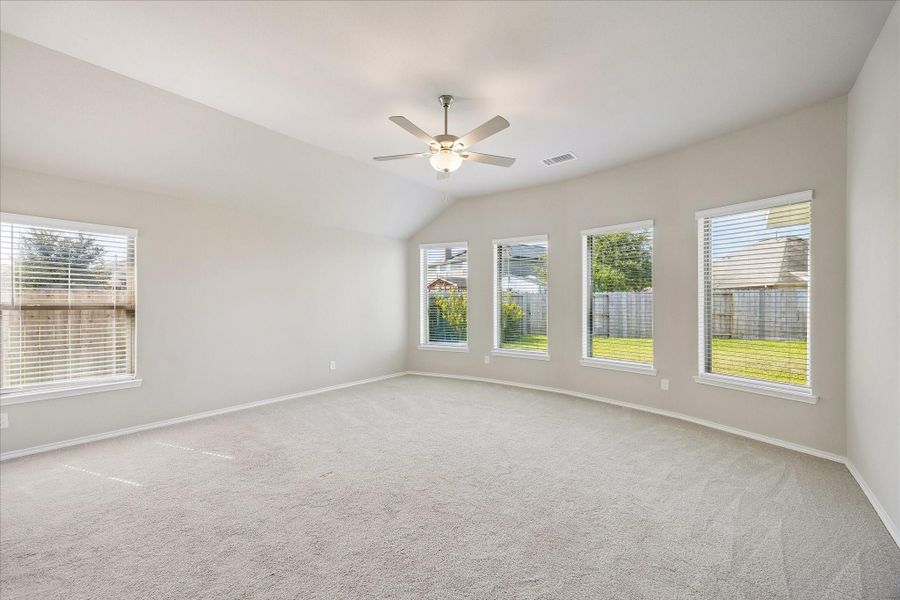The primary suite is oversized with a wall of windows.