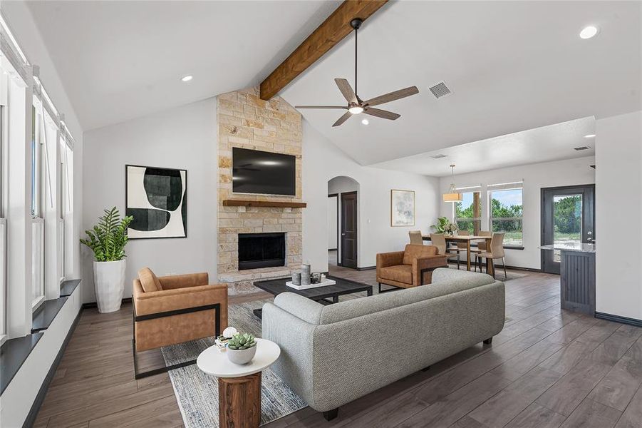Living room with beamed ceiling, ceiling fan, wood finished floors, arched walkways, and recessed lighting