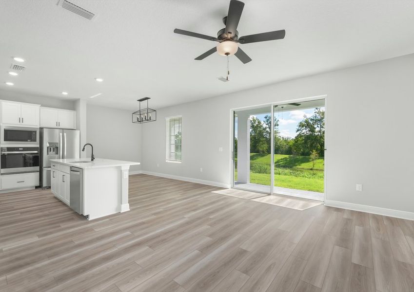 This plan boats an open floorplan that leads to sliding glass doors of the covered back patio.