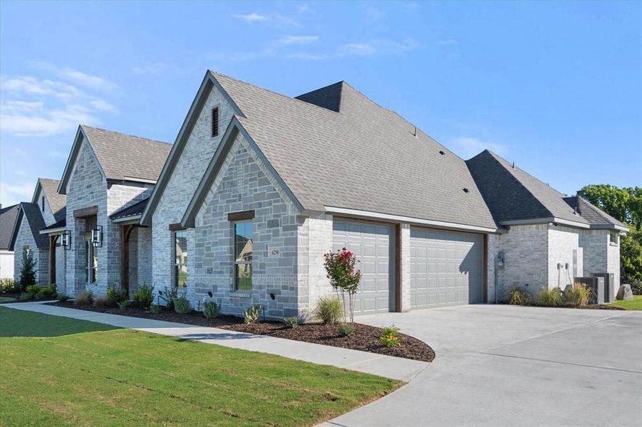 3 car garage with 8ft doors and beautiful landscaping.