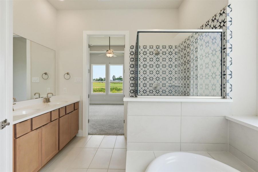 This bath retreat captures natural light while offering privacy and style—a seamless blend of function and charm with scenic views just beyond the glass.