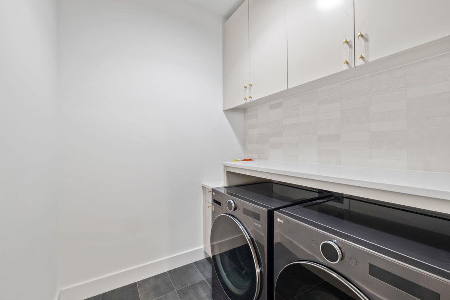 Laundry area with cabinet space and washing machine and clothes dryer