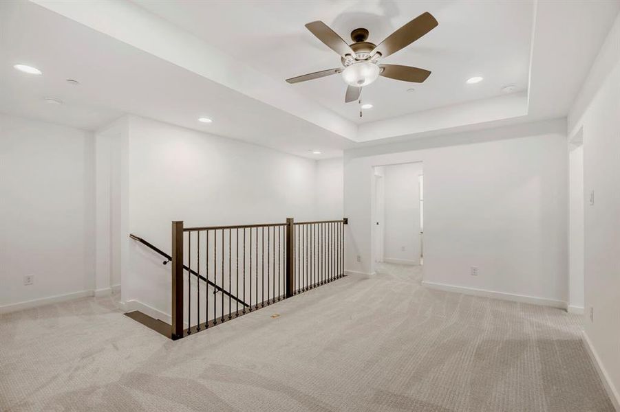 Upper-level space featuring light-toned carpeting, recessed lighting, and a ceiling fan