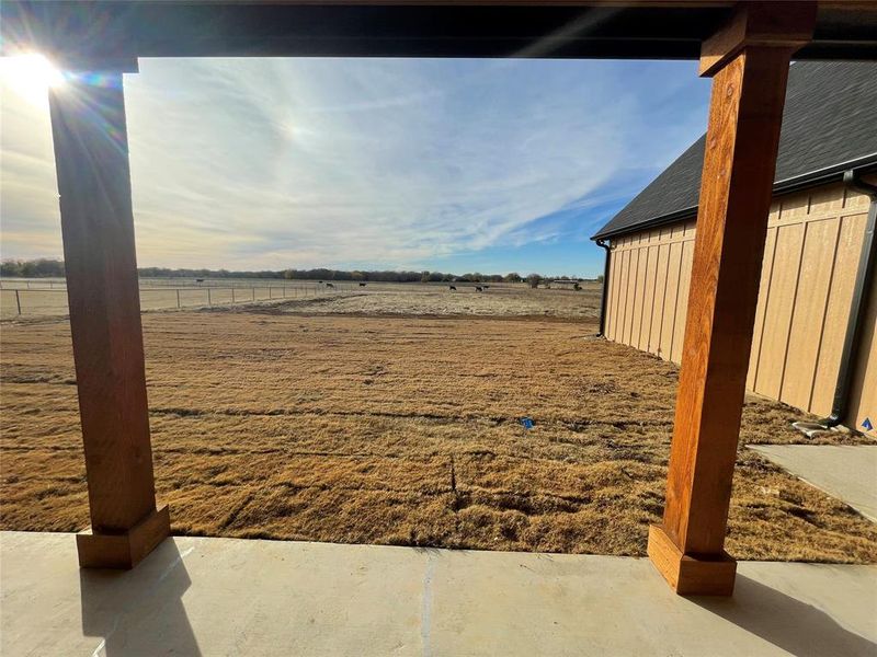 View of yard with a rural view and a patio