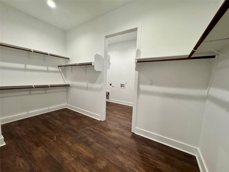 Spacious closet with dark wood finished floors Spacious closet with dark wood finished floors