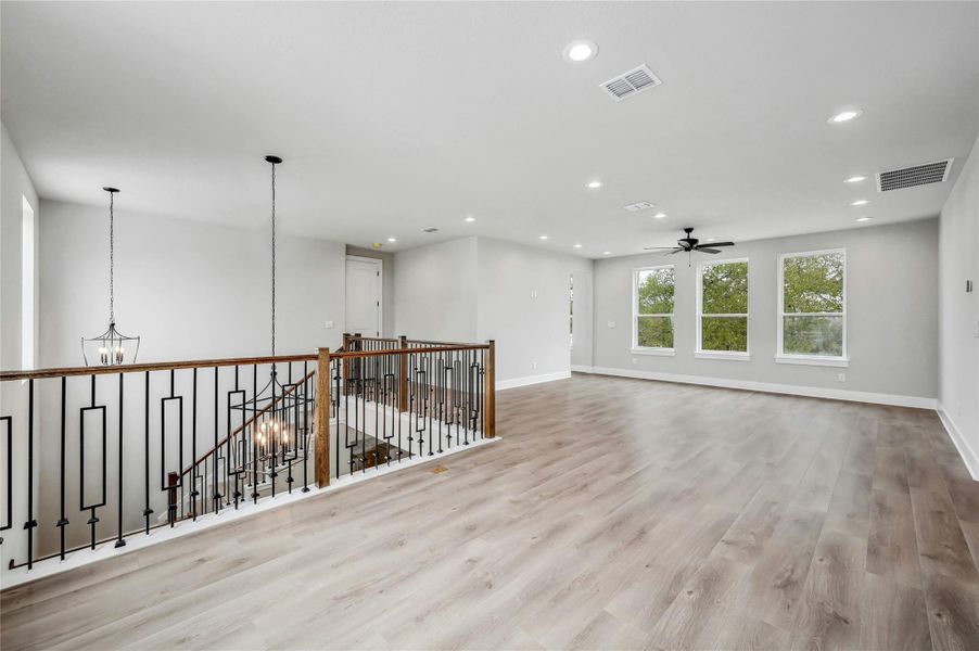 Empty room featuring recessed lighting, visible vents, and wood finished floors