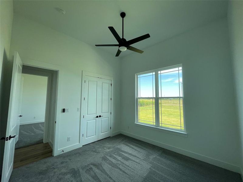 Unfurnished bedroom featuring carpet flooring, a closet, and a ceiling fan Unfurnished bedroom featuring carpet flooring, a closet, and a ceiling fan