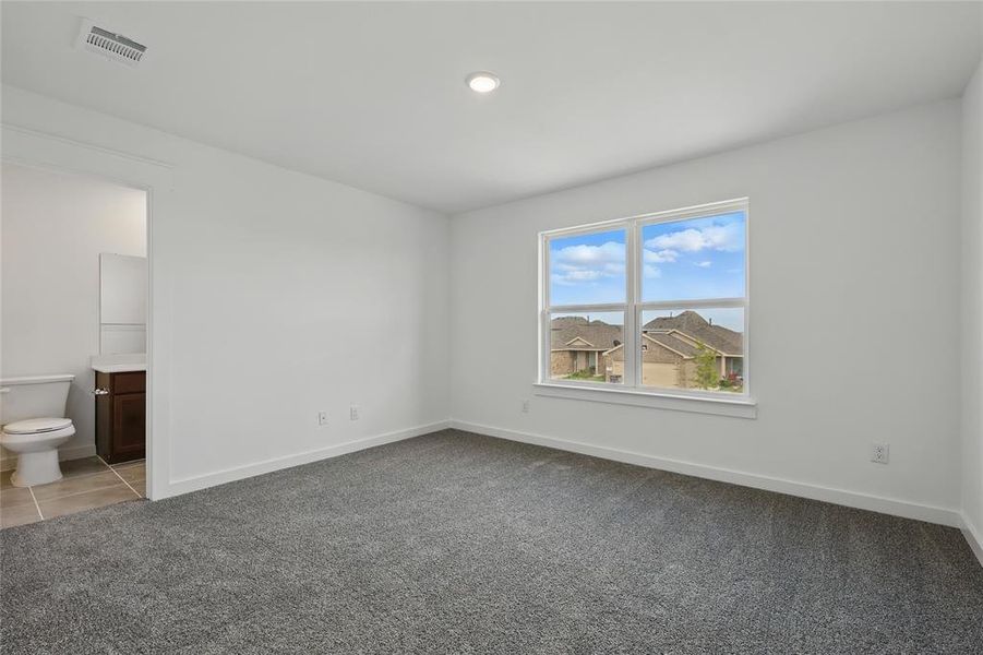 Unfurnished bedroom featuring carpet flooring, ensuite bathroom, and recessed lighting
