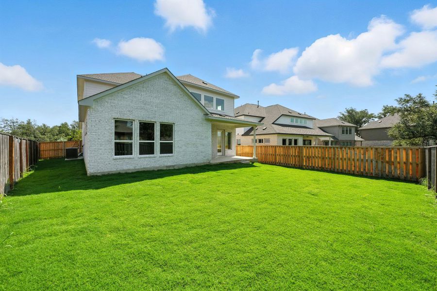 Rear view of property featuring a patio, a fenced backyard, brick siding, and a shingled roof Rear view of property featuring a patio, a fenced backyard, brick siding, and a shingled roof