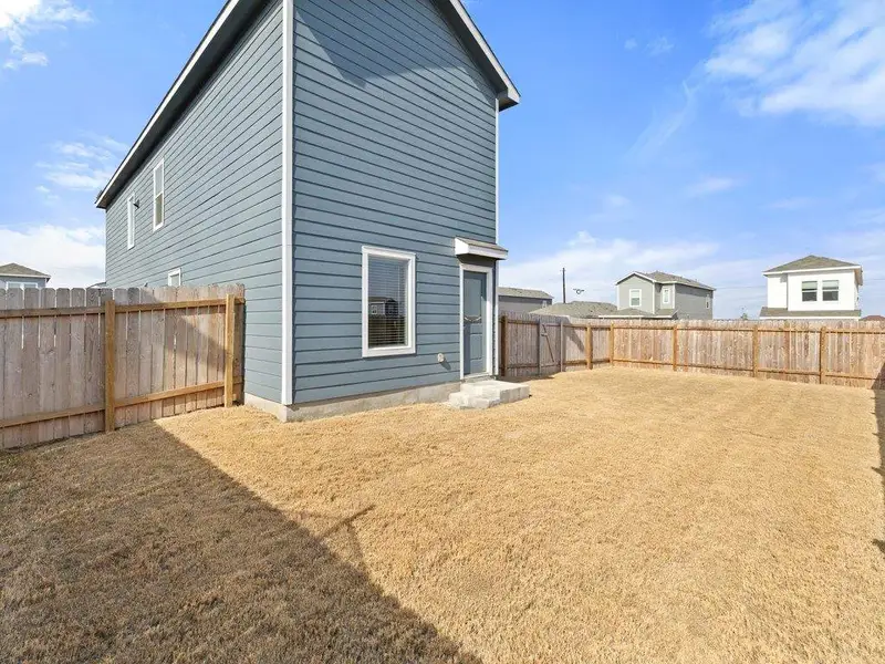 Back of property with a fenced backyard