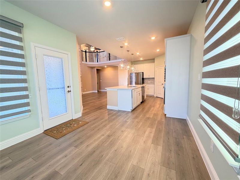 Kitchen with decorative light fixtures, white cabinetry, a center island, recessed lighting, and stainless steel appliances Kitchen with decorative light fixtures, white cabinetry, a center island, recessed lighting, and stainless steel appliances