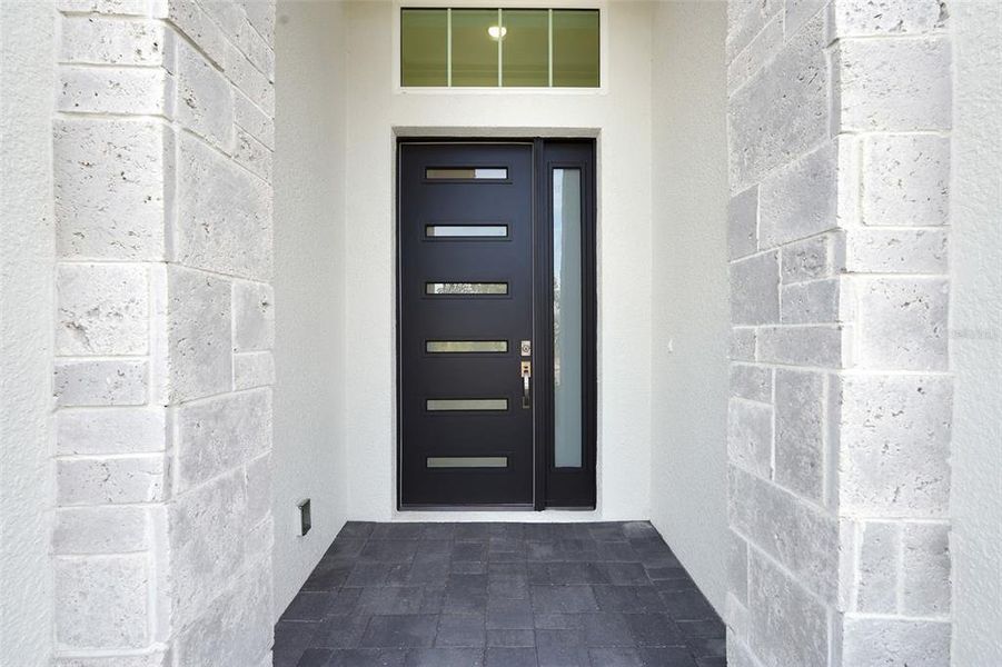 Exterior details and patio area of a home in Hampton Green at Providence, Davenport (Image 3).