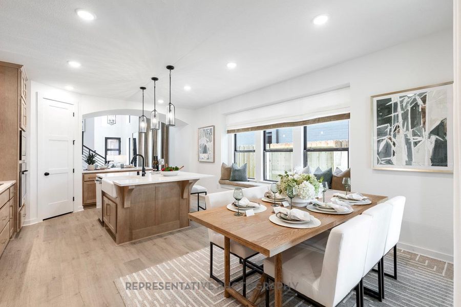 Dining space featuring arched walkways, light wood finished floors, and recessed lighting Dining space featuring arched walkways, light wood finished floors, and recessed lighting