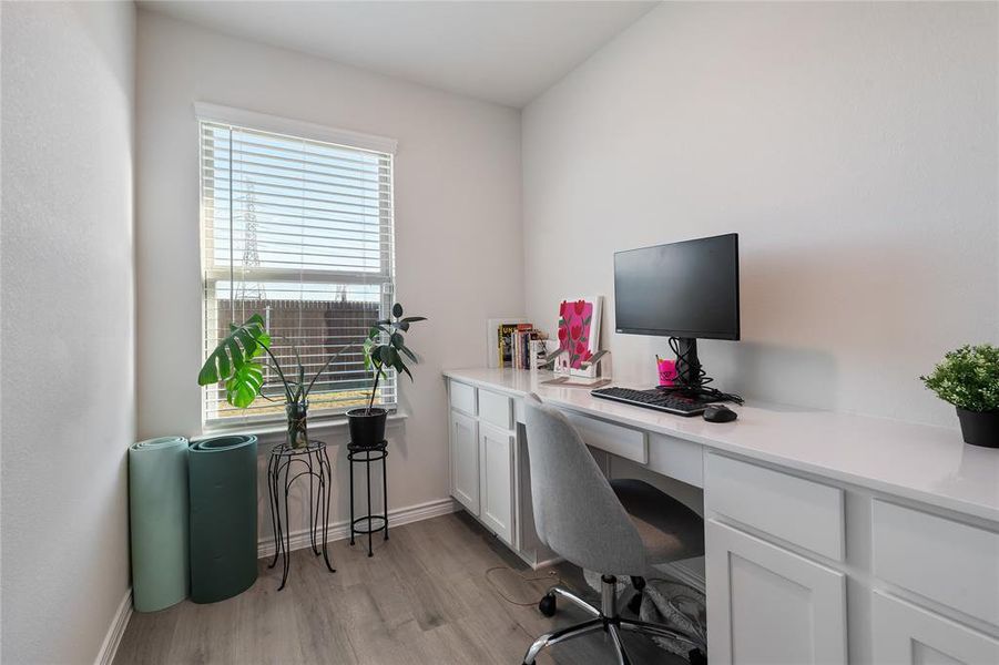 Home office featuring light wood-style floors and baseboards