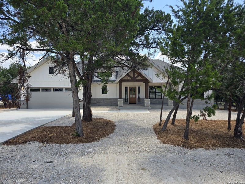 Front exterior of a new home in , Canyon Lake, TX, highlighting curb appeal (Image 32).