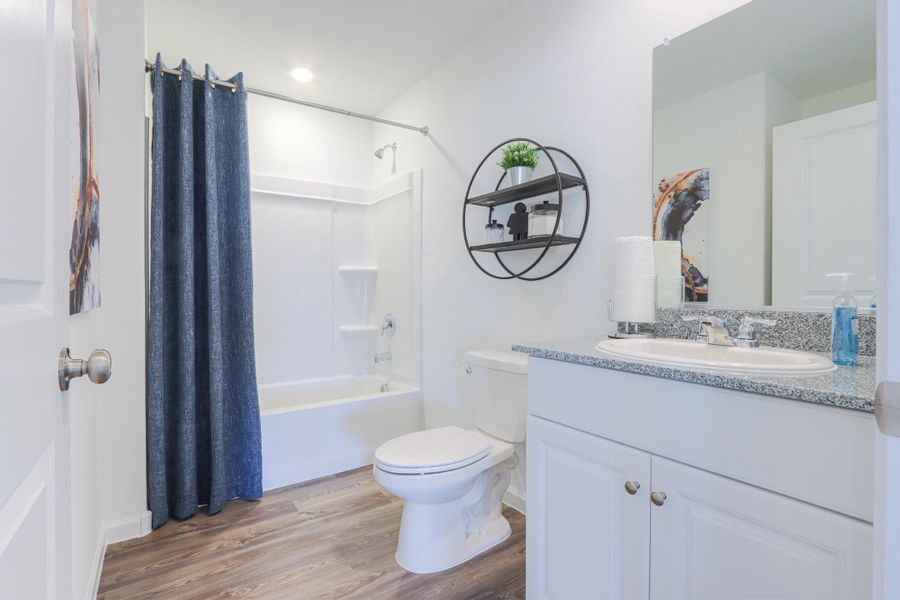 A bathroom with a tub toilet and sink.