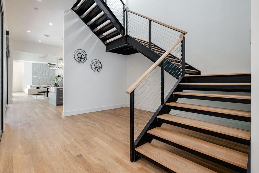 Stairs with hardwood and iron with cable railing