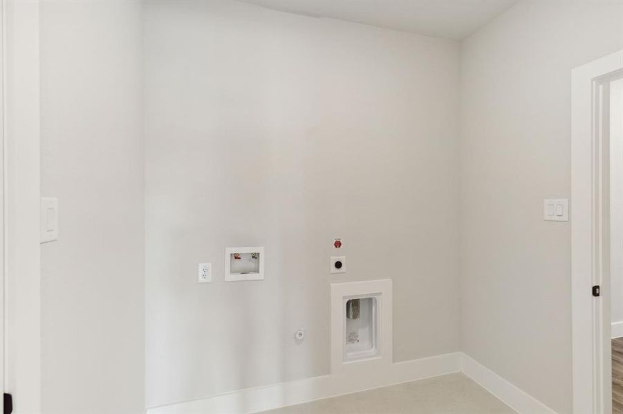 Washroom featuring hookup for an electric dryer, washer hookup, and hookup for a gas dryer