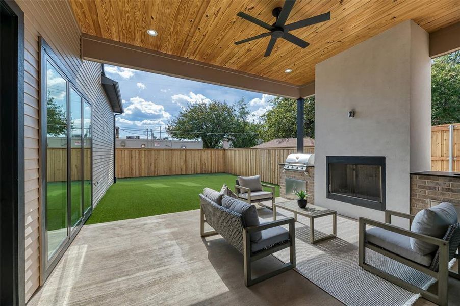 Fenced backyard featuring ceiling fan, a patio, area for grilling, and an outdoor living space Fenced backyard featuring ceiling fan, a patio, area for grilling, and an outdoor living space