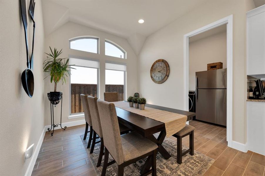 This 16' x 10' morning room is located between the kitchen and game room. The large arched transom windows provide plenty of natural light even when the custom roller shades are down.