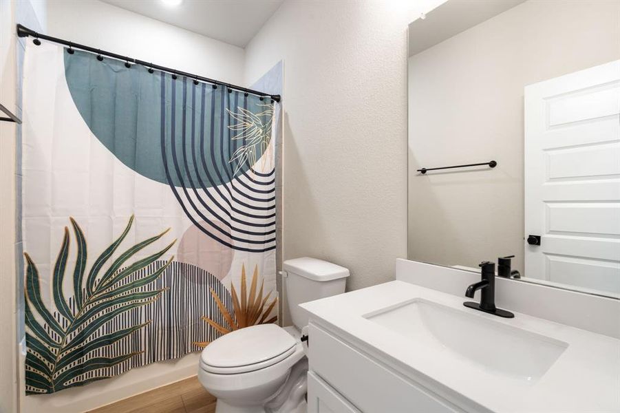 Full bath featuring vanity and shower / bath combo with shower curtain Full bath featuring vanity and shower / bath combo with shower curtain