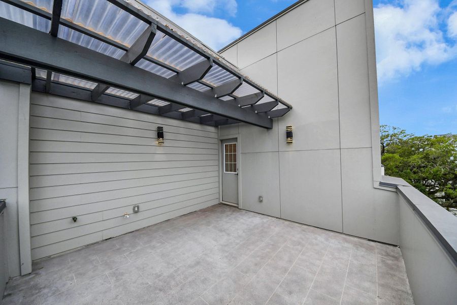 This photo showcases a spacious rooftop patio with a modern pergola, providing ample outdoor space for relaxation or entertaining, enhanced by sleek wall lighting and a neutral color palette. This photo showcases a spacious rooftop patio with a modern pergola, providing ample outdoor space for relaxation or entertaining, enhanced by sleek wall lighting and a neutral color palette.