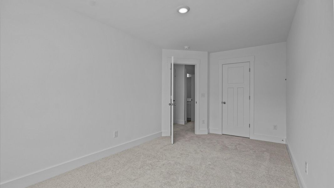 First-rate secondary bedroom with a spacious walk-in closet and elegant carpeted flooring First-rate secondary bedroom with a spacious walk-in closet and elegant carpeted flooring