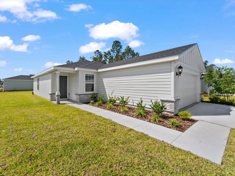 Front exterior of a new home in Flagler Village - Classic Series, Palm Coast, FL, highlighting curb appeal (Image 2). Front exterior of a new home in Flagler Village - Classic Series, Palm Coast, FL, highlighting curb appeal (Image 2).
