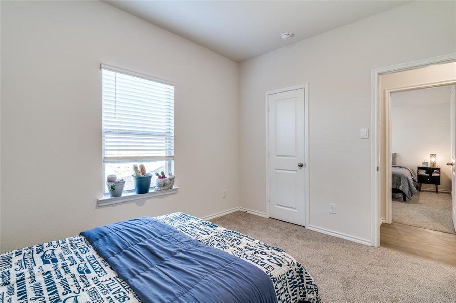 Bedroom featuring carpet flooring and baseboards