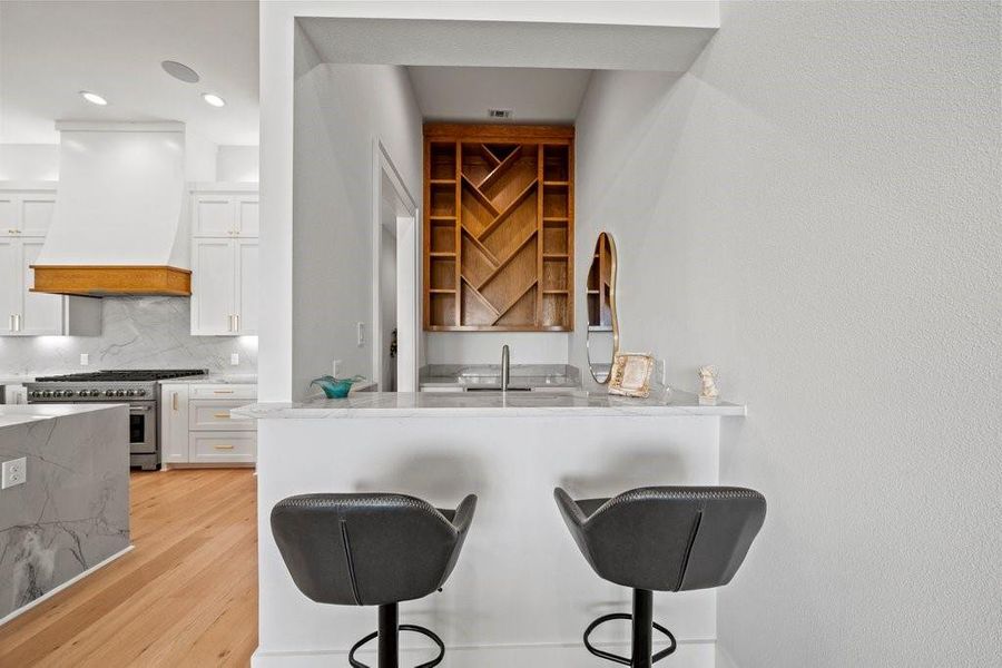Chic and functional, this built-in bar area is perfect for mixing cocktails or morning coffee. Featuring modern finishes and a wood-accented backsplash, it’s a standout space for entertaining in your Canyon Lake home.