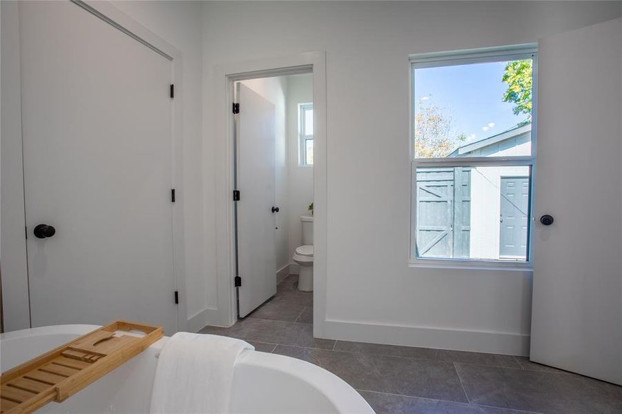 Bathroom featuring toilet and tile patterned floors