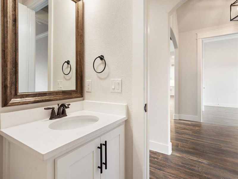 Bathroom with hardwood / wood-style flooring and vanity