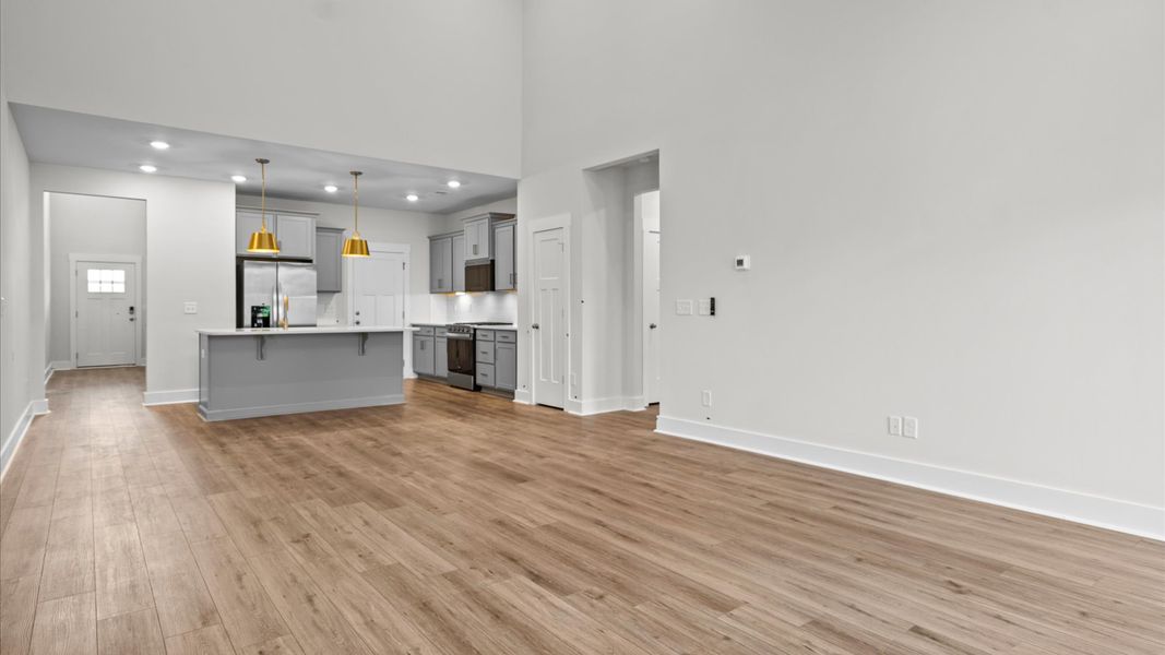 Elegant family room with hardwood flooring and natural light in this accomplished DRB Homes design in Anderson, SC
