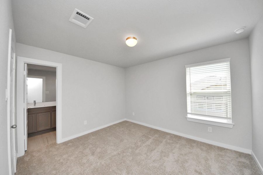 Generously sized secondary bedrooms featuring spacious closets, soft and inviting carpeting underfoot, large windows allowing plenty of natural light, and the added touch of privacy blinds for your personal retreat. Sample photo of completed home with similar floor plan. Actual colors and selections may vary.