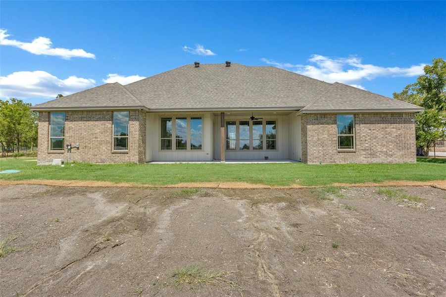 Rear view of house with a lawn