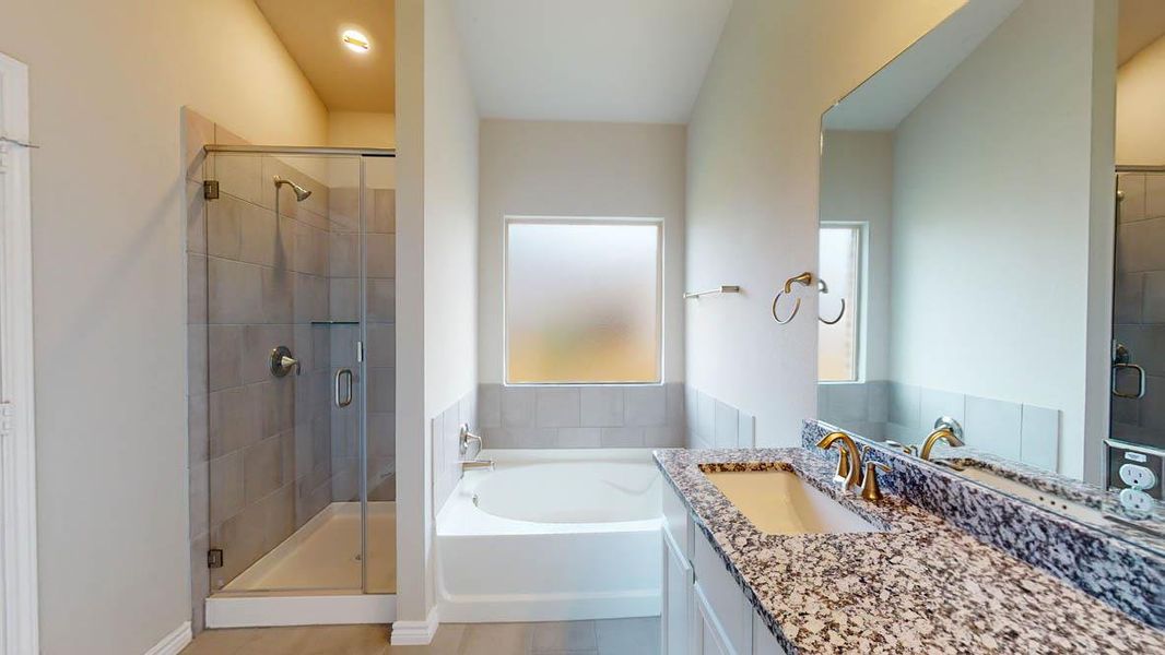 Bathroom featuring vanity, a shower stall, a garden tub, and light wood finished floors