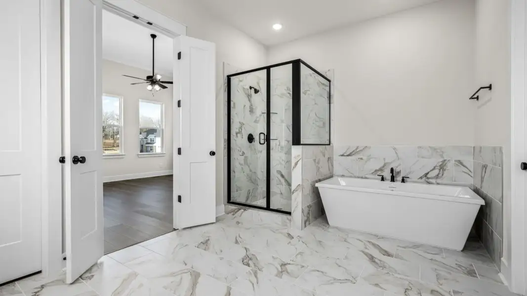 Primary bathroom with shower and bathtub