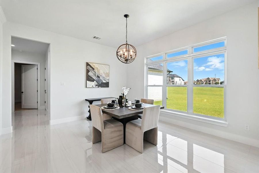 Dining space with a chandelier and baseboards Dining space with a chandelier and baseboards
