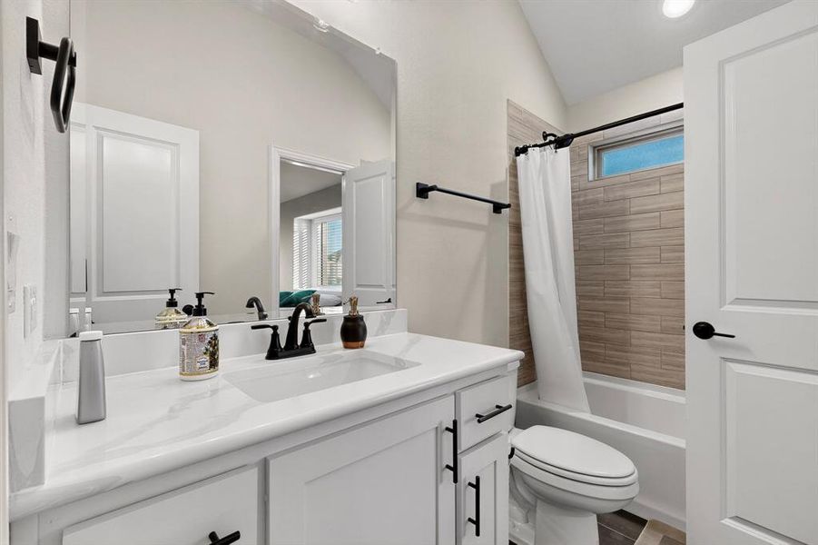 Full bath with healthy amount of natural light, shower / tub combo with curtain, and vanity Full bath with healthy amount of natural light, shower / tub combo with curtain, and vanity