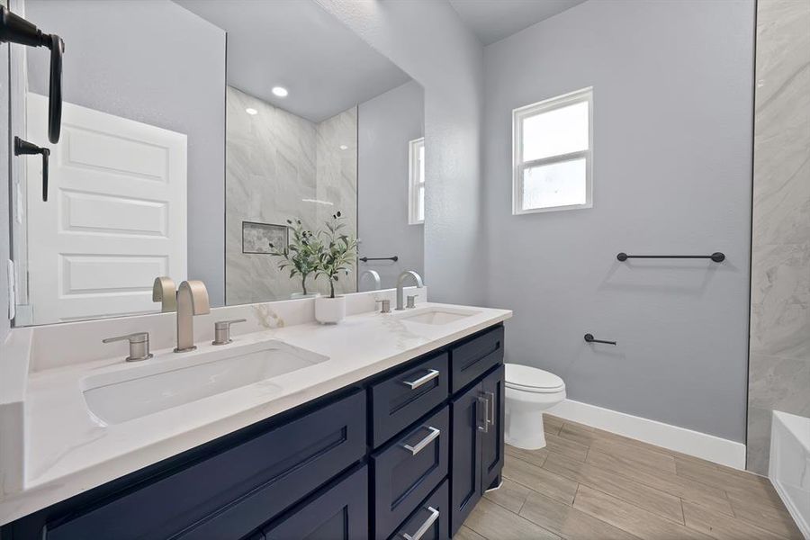 Dual vanity with white solid surface countertop, undermount sinks, and brushed nickel fixtures