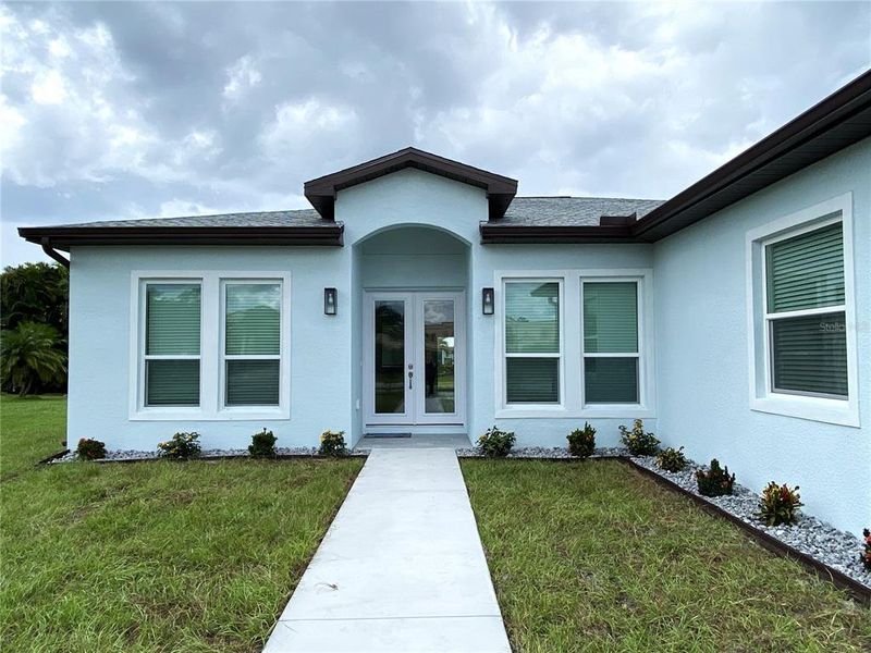 Front exterior of a new home in , Punta Gorda, FL, highlighting curb appeal (Image 1).
