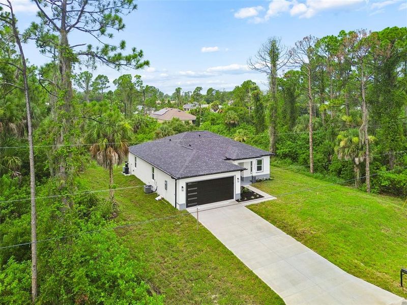 Front exterior of a new home in , North Port, FL, highlighting curb appeal (Image 28). Front exterior of a new home in , North Port, FL, highlighting curb appeal (Image 28).