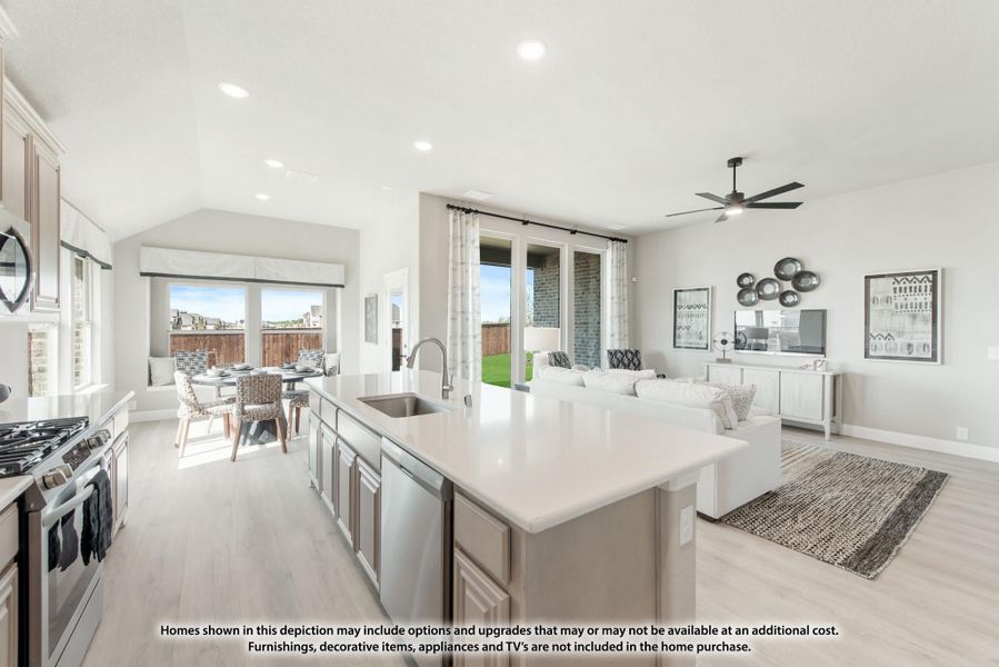 Open-concept kitchen with large island flowing into living and dining areas, light wood floors and patio doors Open-concept kitchen with large island flowing into living and dining areas, light wood floors and patio doors
