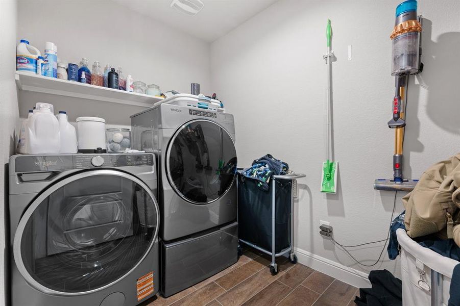 Laundry area with wood finish floors and independent washer and dryer Laundry area with wood finish floors and independent washer and dryer
