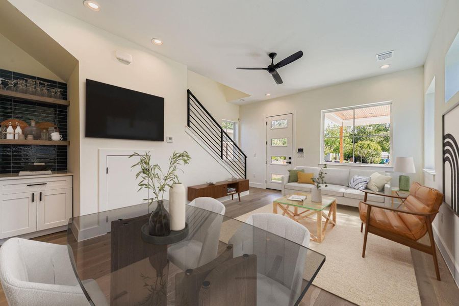 Living room featuring recessed lighting, wood finished floors, stairs, and ceiling fan Living room featuring recessed lighting, wood finished floors, stairs, and ceiling fan