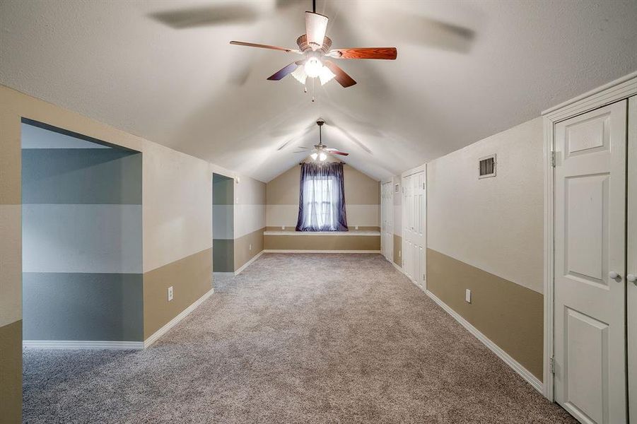Upstairs primary bedroom with ceiling fans and closets Upstairs primary bedroom with ceiling fans and closets