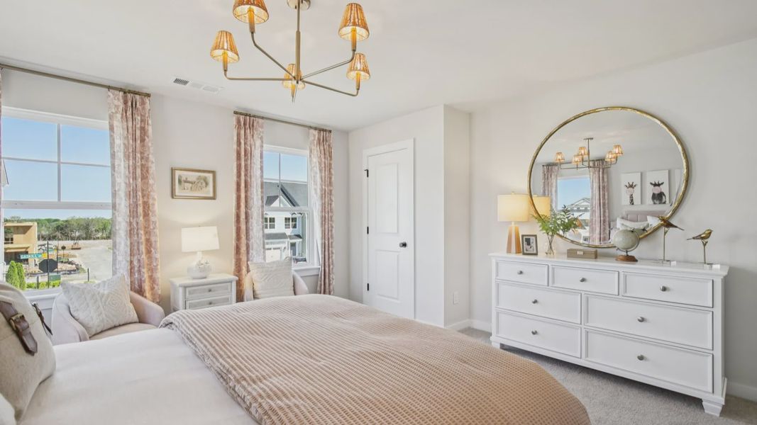 Bedroom with carpet and windows