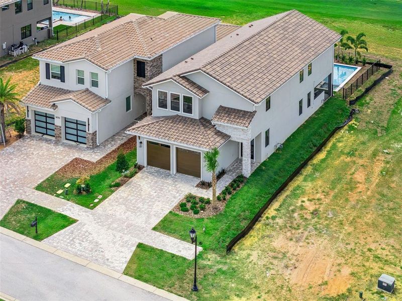 Front exterior of a new home in Bella Collina, Montverde, FL, highlighting curb appeal (Image 21).