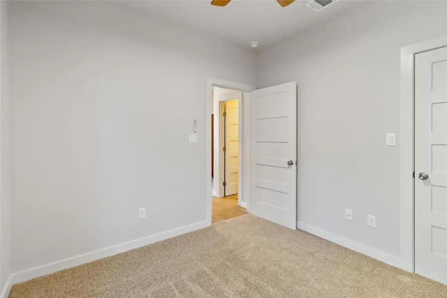 Unfurnished bedroom with carpet flooring and ceiling fan Unfurnished bedroom with carpet flooring and ceiling fan